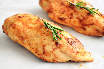 Spicy grilled chicken with herbs and rosemary on parchment paper.