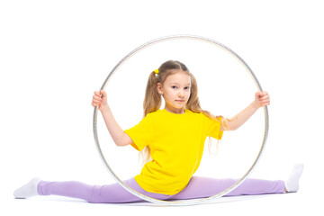 Obraz premium Little cute girl with hula hoop doing stretching. Isolated on white background.