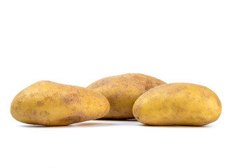 Several raw unpeeled potatoes on a white background.
