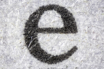Microscopic view of the letter e printed on pulp paper for newspaper