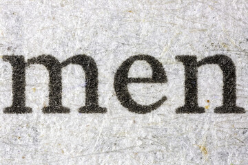 Microscopic view of the word men printed on pulp paper for newspaper
