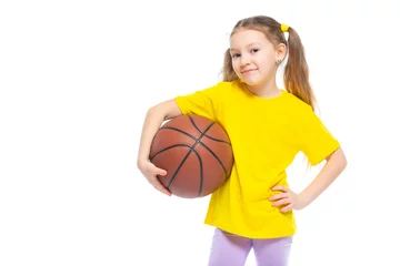 Gardinen Little cute girl holding a basketball in her hand. Isolated on white background. © satyrenko