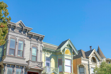 Townhouse exterior in a low angle view with gable roofs in San Francisco, California