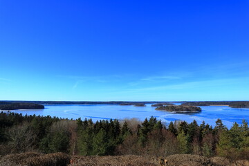Great view over a Swedish landscape during the spring. Ice is still left on the lake. Blue sunny day. Mälaren, Stockholm, Sweden.