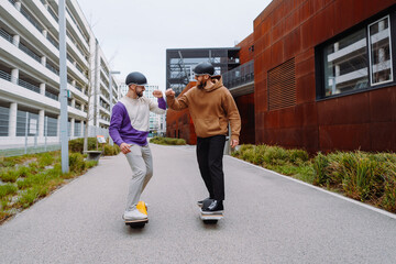 two men on electronic skateboards salute their elbows. the future live style. Urban Background