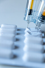 Combination of pills and injections as new medical vaccines ready for injection with syringe and vaccine inject the cure for immunization into ill weak patients painkiller pills drug abuse addiction