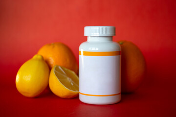white plastic jar with oranges on a red background.