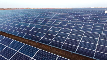 Aerial drone view flight over solar panels on sunny day close-up. Photovoltaic solar panel. Moving...