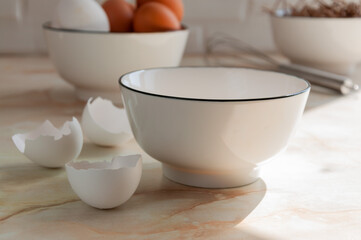 Eggs in a ceramic cup close-up. Cooking in the kitchen. White and brown eggs. Sunny morning. Preparing breakfast. selective focus
