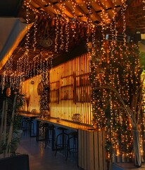 Garlands of gold color in the bar.  LED lighting in the cafe.  Bar design with lanterns. 