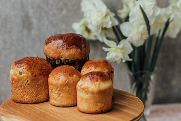 Delicious Easter cakes on a wooden table with flowers in the background. place for text. selective focus