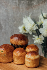Delicious Easter cakes on a wooden table with flowers in the background. place for text. selective focus