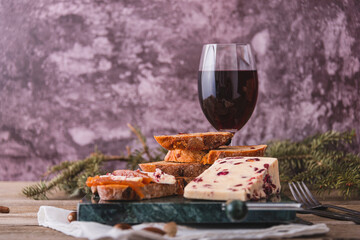 Delicious British Cheddar cheese with cranberry on a marble cheese cutting table.