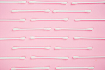 Cotton buds on a pink background.