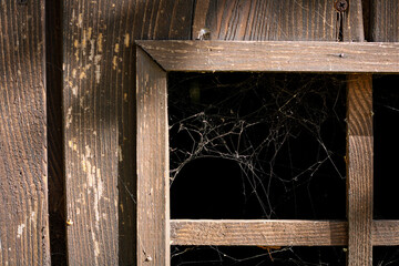 wooden window with spider's web