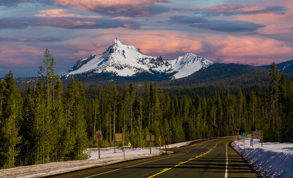 Mt Theilsen under a sunrise sky covered with snow and state Highway 230 near Diamond Lake and the summit of the Cascade mountains, Oregon, USA