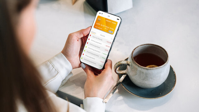 Internet based banking. Girl holding mobile phone with internet online bank app. Credit card wallet application. Online wallet save money.