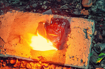 Top view of a man's glove that starts to burn. White yellow flame.