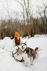 young woman outdoors in a field in winter walking with a dog Lifestyle