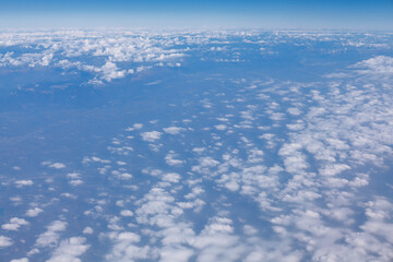 Naklejka na ściany i meble Above the altocumulus clouds . Flight over the earth 