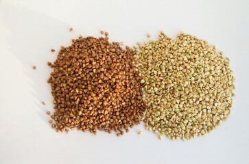 cereals of buckwheat and green unboiled buckwheat on a white background