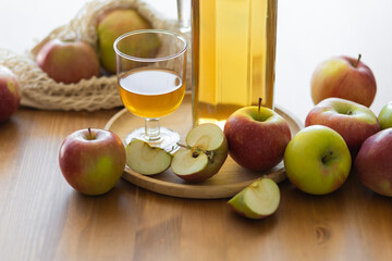 Fresh homemade organic apple juice or cider on a wooden table in a glass jug