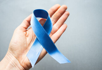 blue ribbon in hand prostate cancer awareness