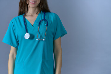 nurse smiling woman with stethoscope on flat background with copy space front view