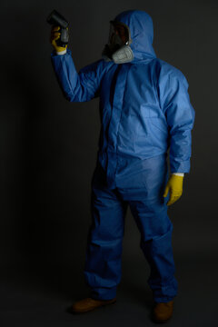anti radioactive chemical suit with gas mBask gloves on gray background and dramatic detector