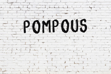 Inscription pompous painted on white brick wall - obrazy, fototapety, plakaty