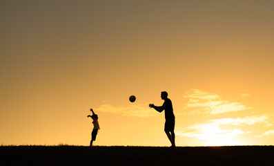 Happy father son relationship. silhouette of dad and child playing together in the park at sunset