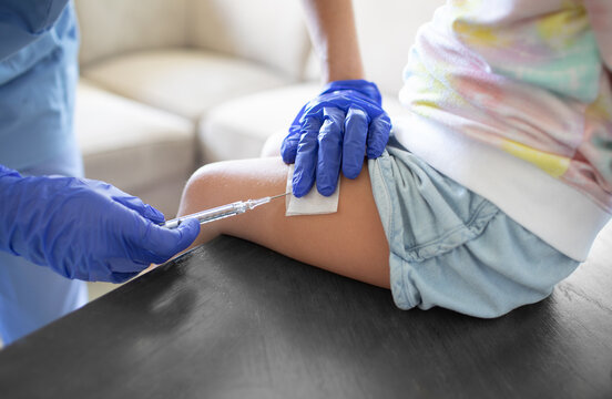 child getting shot vaccine in leg 