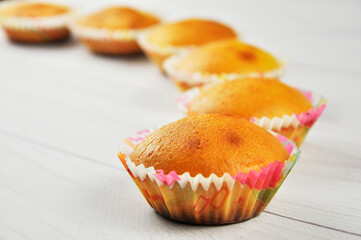Homemade cupcakes on wooden table.