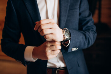 businessman in suit looking at wrist watch