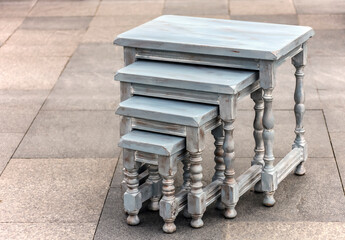 Set of old wooden painted stools at street sale.