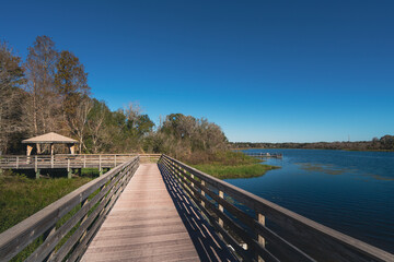 Boardwalk on water at Lake Lotus nature park in Altamonte Springs, a suburb of greater Orlando area in Florida