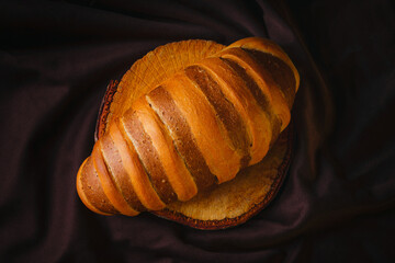 Freshly baked wheat or rye bread on wooden surface