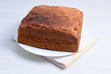 Homemade vanilla cake, displayed on plate and wooden background