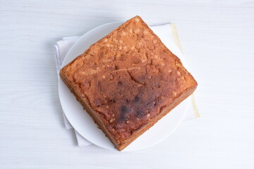 Homemade vanilla cake, displayed on plate and wooden background