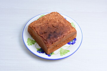 Homemade vanilla cake, displayed on plate and wooden background