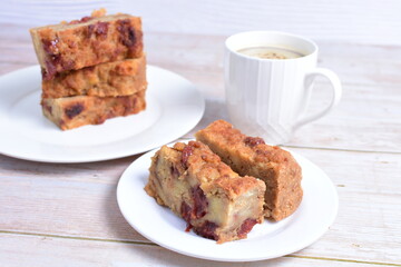 Fluffy bread cake with guava flavor accompanied by a cup of coffee on a wooden background