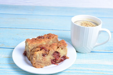 Fluffy bread cake with guava flavor accompanied by a cup of coffee on a wooden background