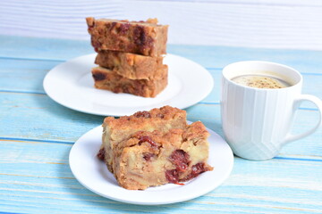 Fluffy bread cake with guava flavor accompanied by a cup of coffee on a wooden background