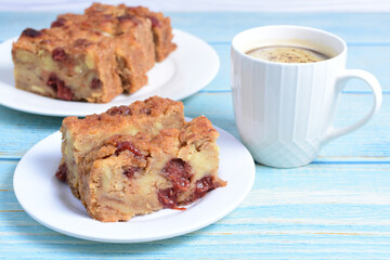 Fluffy bread cake with guava flavor accompanied by a cup of coffee on a wooden background