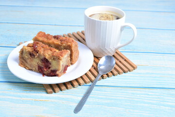 Fluffy bread cake with guava flavor accompanied by a cup of coffee on a wooden background