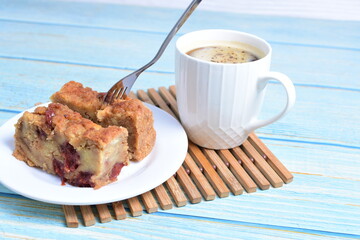 Fluffy bread cake with guava flavor accompanied by a cup of coffee on a wooden background