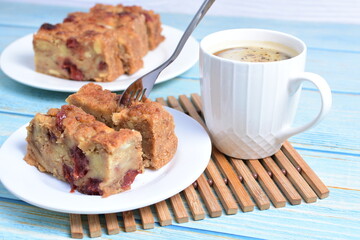 Fluffy bread cake with guava flavor accompanied by a cup of coffee on a wooden background