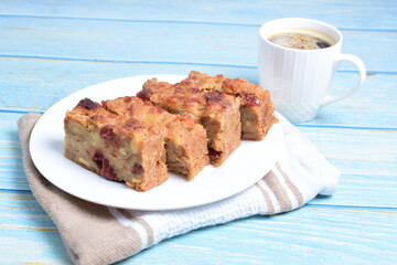 Fluffy bread cake with guava flavor accompanied by a cup of coffee on a wooden background