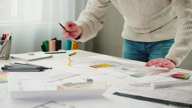 Architect designer workplace close-up. Professional engineer choosing color palette, interior creator working with house project, blueprint plan, drafting building.