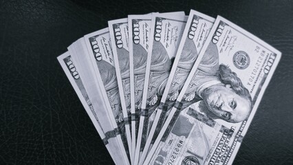 black and white Tone color of One Hundred U.S. Dollar Bills with Narrow Depth of Field on black background
